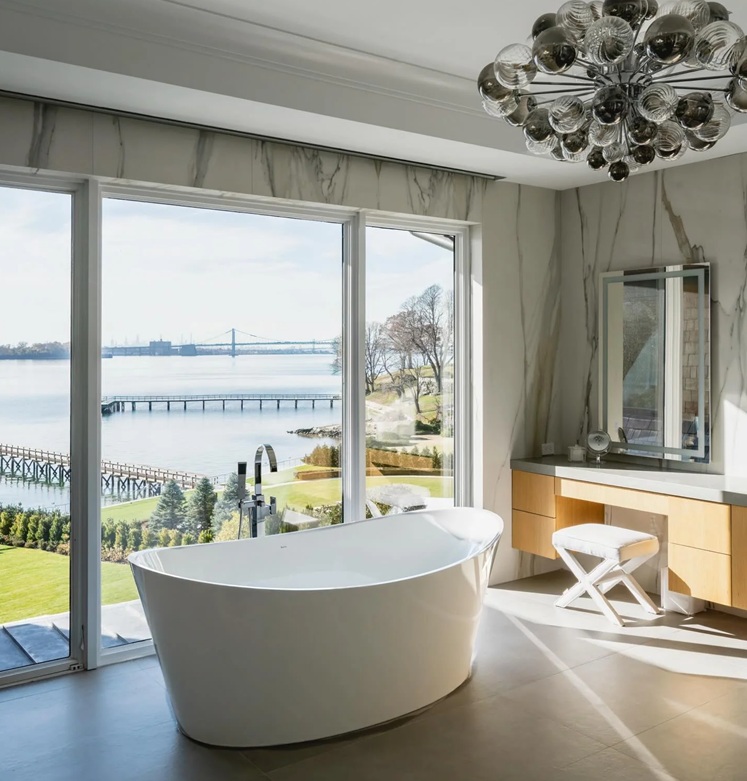 A dream bath room overlooking a bridge vista with the Bainultra Evanescence bathtub in white